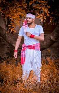 Full length of man standing on field during autumn