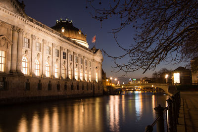 River by bode museum in illuminated city at night