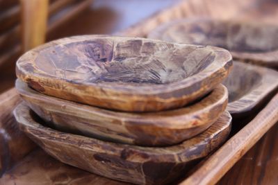 Close-up of old bowls stacked on table