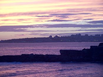 Scenic view of river at sunset