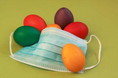 High angle view of multi colored candies against yellow background