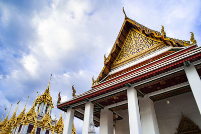 Low angle view of temple building against cloudy sky