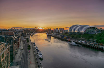 Bridge over river against sky during sunset