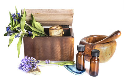 Lavenders with mortar and pestle with box against white background