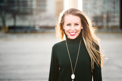 Young woman smiling outdoors