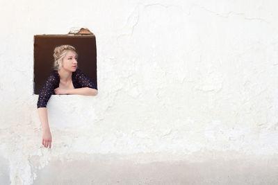 Woman leaning at window