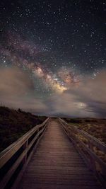 Empty road against sky at night