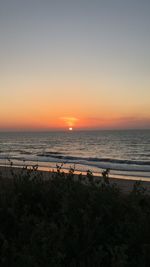 Scenic view of sea against clear sky during sunset