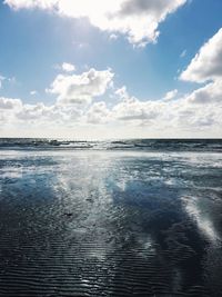 Scenic view of sea against cloudy sky