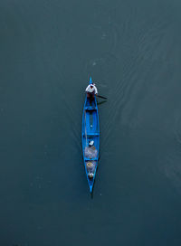 High angle view of man sitting in fishing boat on sea