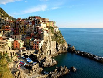 Panoramic view of sea and buildings against sky