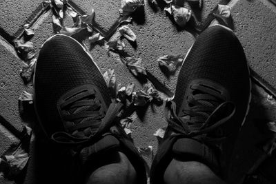 Low section of man wearing shoes