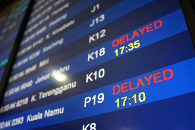 Close-up of text on wall at airport