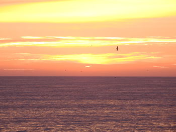 Scenic view of sea against orange sky