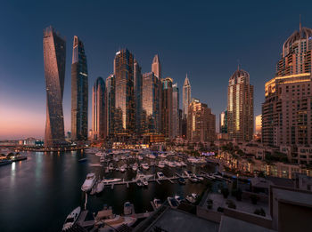 Panoramic view of illuminated buildings in city against sky