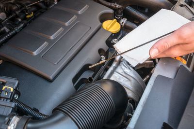 Close-up of man repairing car engine