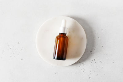 High angle view of bottle on white table