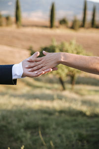 Cropped image of couple holding hands