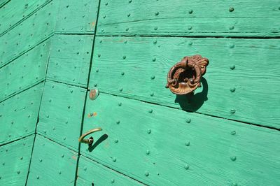 High angle view of metal door on wood