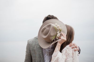 Bride and bridegroom standing at beach during wedding ceremony