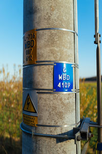 Close-up of information sign against clear sky