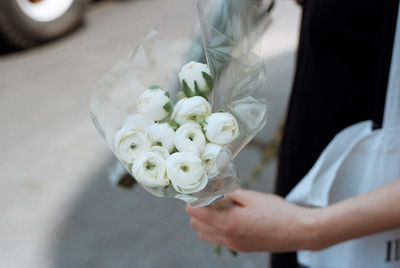 Close-up of hand holding flower bouquet