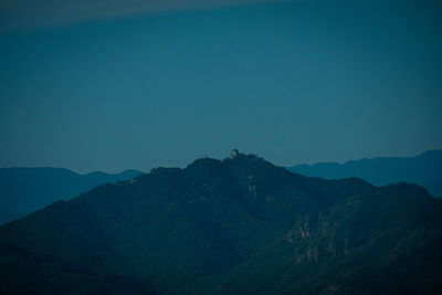 Scenic view of mountains against clear blue sky