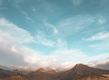 View of mountain range against cloudy sky