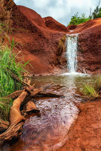 Scenic view of waterfall against rocks