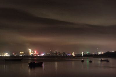 Illuminated boats in river at night