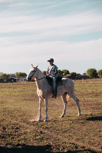 Rural scene boy horseback riding
