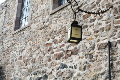 Low angle view of an historical electric lamp on wall