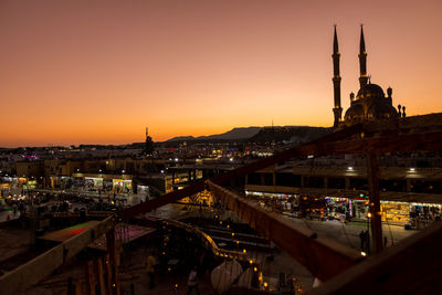 Panoramic top view of al sahab mosque and old town at sunset. silhouettes of people in shopping 