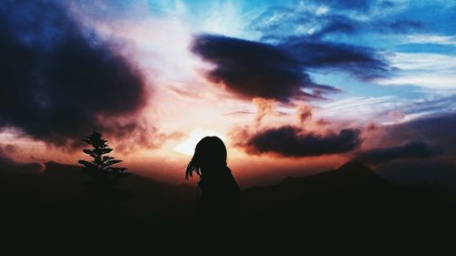 Silhouette man against sky during sunset