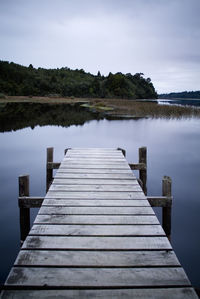 Pier over lake against sky