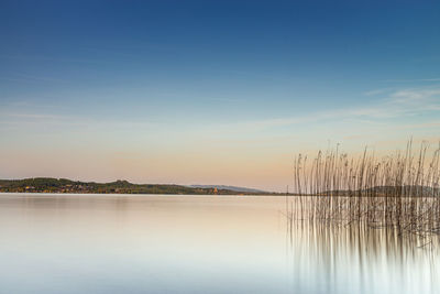 Scenic view of lake against sky during sunset