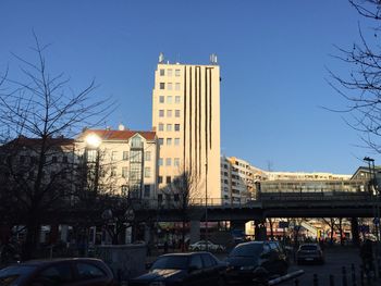 View of city street against blue sky