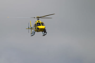 Low angle view of helicopter against clear sky