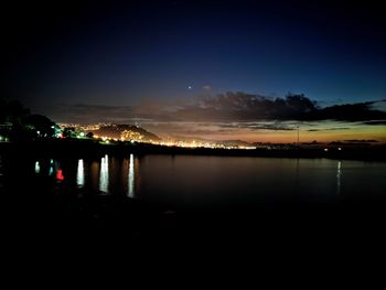 Scenic view of lake against sky at night