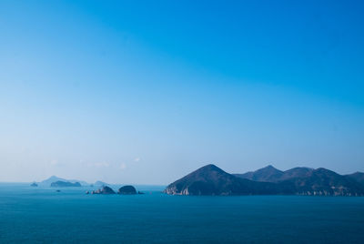 Scenic view of sea against clear blue sky