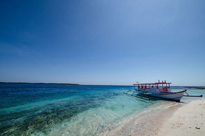 Fishing boat on sea against sky