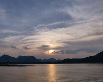 Scenic view of lake against sky during sunset