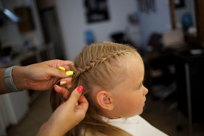 Portrait of woman holding baby hand