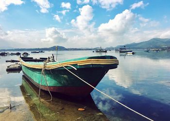 Boats moored on sea against sky