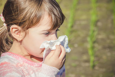 Close-up of girl blowing bubbles