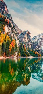 Scenic view of lake by mountain against sky