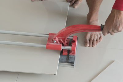 Low section of worker installing tile