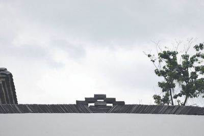 Low angle view of building against clouds