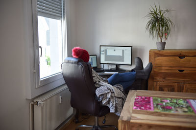 Young woman working from home in winter