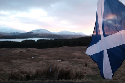 Scenic view of landscape against cloudy sky